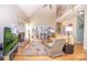 Spacious living room with a vaulted ceiling, brick fireplace, built-in bookshelves, and hardwood floors at 11724 Brambleton Ct, Charlotte, NC 28277