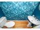Unique powder room featuring blue patterned wallpaper, hardwood floors, and a pedestal sink at 11724 Brambleton Ct, Charlotte, NC 28277