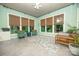 Bright sunroom with lots of natural light, neutral color scheme, and tile flooring at 11724 Brambleton Ct, Charlotte, NC 28277