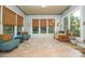 Bright sunroom with lots of natural light, neutral color scheme, and tile flooring at 11724 Brambleton Ct, Charlotte, NC 28277