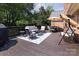 The back deck features a seating area, patio furniture, and a beautiful tree-lined view at 1208 Chausley Ct, Charlotte, NC 28211
