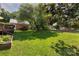 Well-manicured backyard with a large shade tree, wooden fence, and an attached deck at 1208 Chausley Ct, Charlotte, NC 28211