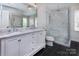 Modern bathroom with marble countertops, dual sinks, and a glass-enclosed shower at 1208 Chausley Ct, Charlotte, NC 28211