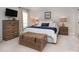 Comfortable bedroom with a dresser, bedside tables, and bright, natural light at 1208 Chausley Ct, Charlotte, NC 28211