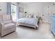 Bright bedroom with a comfortable chair, patterned bedding, and soft, natural light at 1208 Chausley Ct, Charlotte, NC 28211