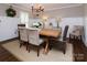 Elegant dining room with wainscoting, a wooden table, and stylish seating at 1208 Chausley Ct, Charlotte, NC 28211
