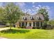 Traditional brick home with manicured lawn, dormer windows, and inviting entrance at 1208 Chausley Ct, Charlotte, NC 28211