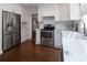 Modern kitchen with stainless appliances, white cabinets, and hardwood flooring at 1208 Chausley Ct, Charlotte, NC 28211