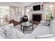 Bright living room with a brick fireplace, hardwood floors, and comfortable seating at 1208 Chausley Ct, Charlotte, NC 28211