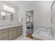 This is a well-lit bathroom featuring double sinks with marble countertops at 1241 Rollins Ave, Charlotte, NC 28205