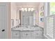 Updated bathroom with granite counters, new fixtures, and a large mirror at 1241 Rollins Ave, Charlotte, NC 28205