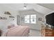 Attic bedroom with a large window, carpet, and soft pink bedding at 1241 Rollins Ave, Charlotte, NC 28205