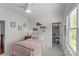Cozy bedroom with a fan, a window with natural light, and a walk-in closet with a built-in desk at 1241 Rollins Ave, Charlotte, NC 28205