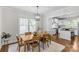 Bright dining room with hardwood floors, adjacent to a stylish, modern kitchen with stainless steel appliances at 1241 Rollins Ave, Charlotte, NC 28205