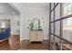 Bright foyer with hardwood floors, decorative mirror, and stylish decor creating a warm and inviting entry space at 1241 Rollins Ave, Charlotte, NC 28205