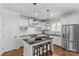 Modern kitchen with island seating, stainless appliances, and white cabinetry at 1241 Rollins Ave, Charlotte, NC 28205