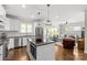 Contemporary kitchen with island, stainless steel appliances, and opens to the living room at 1241 Rollins Ave, Charlotte, NC 28205