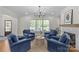 Cozy living room with a fireplace, hardwood floors, and comfortable seating, perfect for relaxing and entertaining at 1241 Rollins Ave, Charlotte, NC 28205