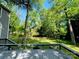 Large backyard view from the gray deck, featuring a fire pit and a wood fence surrounding the landscape at 12610 Angel Oak Dr, Huntersville, NC 28078
