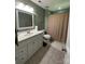 This bathroom features a mirror, sink, white cabinets, and light tile flooring at 12610 Angel Oak Dr, Huntersville, NC 28078
