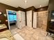 This bathroom features double sinks, a walk in shower, tile floor, and dark colored walls at 12610 Angel Oak Dr, Huntersville, NC 28078
