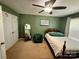 This bedroom features a ceiling fan, chair, hardwood flooring, and white trim at 12610 Angel Oak Dr, Huntersville, NC 28078