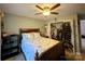 This bedroom features a ceiling fan, open closet, and a patterned comforter at 12610 Angel Oak Dr, Huntersville, NC 28078