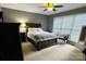 Calm bedroom featuring a large window, ceiling fan, and neutral carpet at 12610 Angel Oak Dr, Huntersville, NC 28078