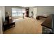 This bonus room features many windows, neutral paint, carpet flooring, and a desk at 12610 Angel Oak Dr, Huntersville, NC 28078