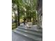 Relax on this gray deck with outdoor seating and views of the lush green landscape and wooded property at 12610 Angel Oak Dr, Huntersville, NC 28078