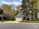 Charming two-story home featuring a well-manicured lawn, mature trees, and a two-car garage at 12610 Angel Oak Dr, Huntersville, NC 28078