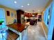 Eat-in kitchen features granite countertops, stainless steel appliances, an island with seating, and wooden cabinets at 12610 Angel Oak Dr, Huntersville, NC 28078