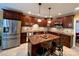 Modern kitchen featuring stainless steel appliances, granite countertops, an island with seating, and wooden cabinets at 12610 Angel Oak Dr, Huntersville, NC 28078