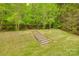 Beautifully landscaped backyard with mature trees and a natural staircase at 12719 Vantage Point Ln, Huntersville, NC 28078