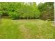 Spacious backyard with tiered landscaping, leading to a wooded area at 12719 Vantage Point Ln, Huntersville, NC 28078