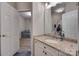 Bathroom featuring a single sink vanity with stone countertop and a view of another room through the door at 12719 Vantage Point Ln, Huntersville, NC 28078