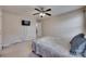Neutrally decorated bedroom features carpeted floors, ceiling fan and mounted TV at 12719 Vantage Point Ln, Huntersville, NC 28078