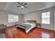 Bright bedroom featuring a ceiling fan and hardwood floors with multiple windows at 12719 Vantage Point Ln, Huntersville, NC 28078