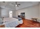 Spacious bedroom features hardwood floors, ceiling fan and entertainment center at 12719 Vantage Point Ln, Huntersville, NC 28078