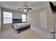 Cozy bedroom with neutral walls, carpeted floor, and a ceiling fan at 12719 Vantage Point Ln, Huntersville, NC 28078
