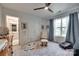 Inviting bedroom with natural light, soft rug, and an adjacent bathroom at 12719 Vantage Point Ln, Huntersville, NC 28078