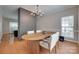 Elegant dining room with a modern chandelier, a large window, and hardwood floors for Gathering gatherings at 12719 Vantage Point Ln, Huntersville, NC 28078