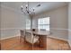 Dining room featuring hardwood floors, neutral wall paint and natural light from the two large windows at 12719 Vantage Point Ln, Huntersville, NC 28078