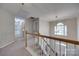 Bright hallway features carpeted floor and railing that overlooks the front entry at 12719 Vantage Point Ln, Huntersville, NC 28078