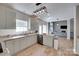 Well-lit kitchen featuring granite counters, wood flooring, stainless steel appliances and direct access to the living room at 12719 Vantage Point Ln, Huntersville, NC 28078