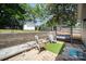 Inviting backyard patio area with a swing, seating, and a small patch of artificial turf for a cozy outdoor retreat at 131 Swink Sw St, Concord, NC 28027