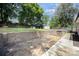 Spacious backyard featuring a retaining wall, ample green space, and a partially paved area for outdoor activities at 131 Swink Sw St, Concord, NC 28027