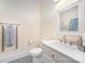 Bright bathroom with a white vanity, modern fixtures, and stylish black-and-white patterned flooring at 131 Swink Sw St, Concord, NC 28027