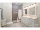Bright bathroom featuring double sink vanity and tiled walk-in shower at 131 Swink Sw St, Concord, NC 28027