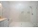 Bright bathroom with walk-in shower and clear glass door with bench and vanity at 131 Swink Sw St, Concord, NC 28027
